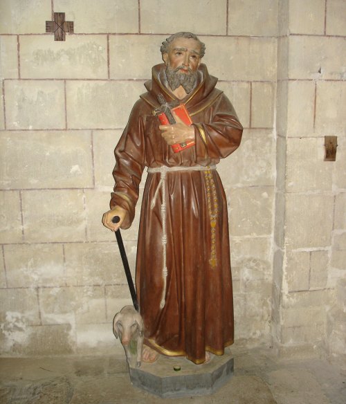 Statue de saint Antoine et son cochon, à la collégiale d'Uzeste (Gironde)