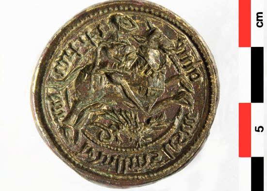 Matrice de sceau avec au centre gravé en creux un cavalier (saint Georges) surplombant un dragon, entouré d'une légende en lettres gothiques, puis d'un cercle perlé